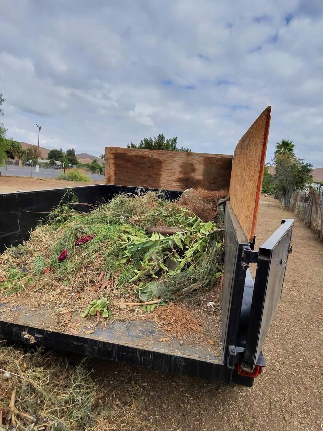 Trailer loaded with yard waste and branches