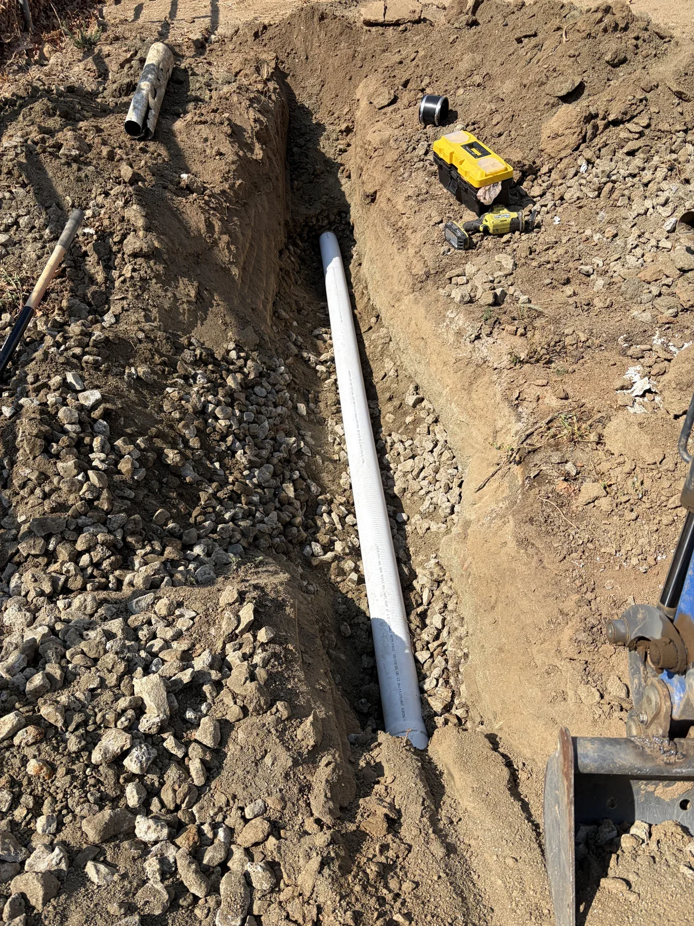 Replacement drainage pipe in an open yard trench