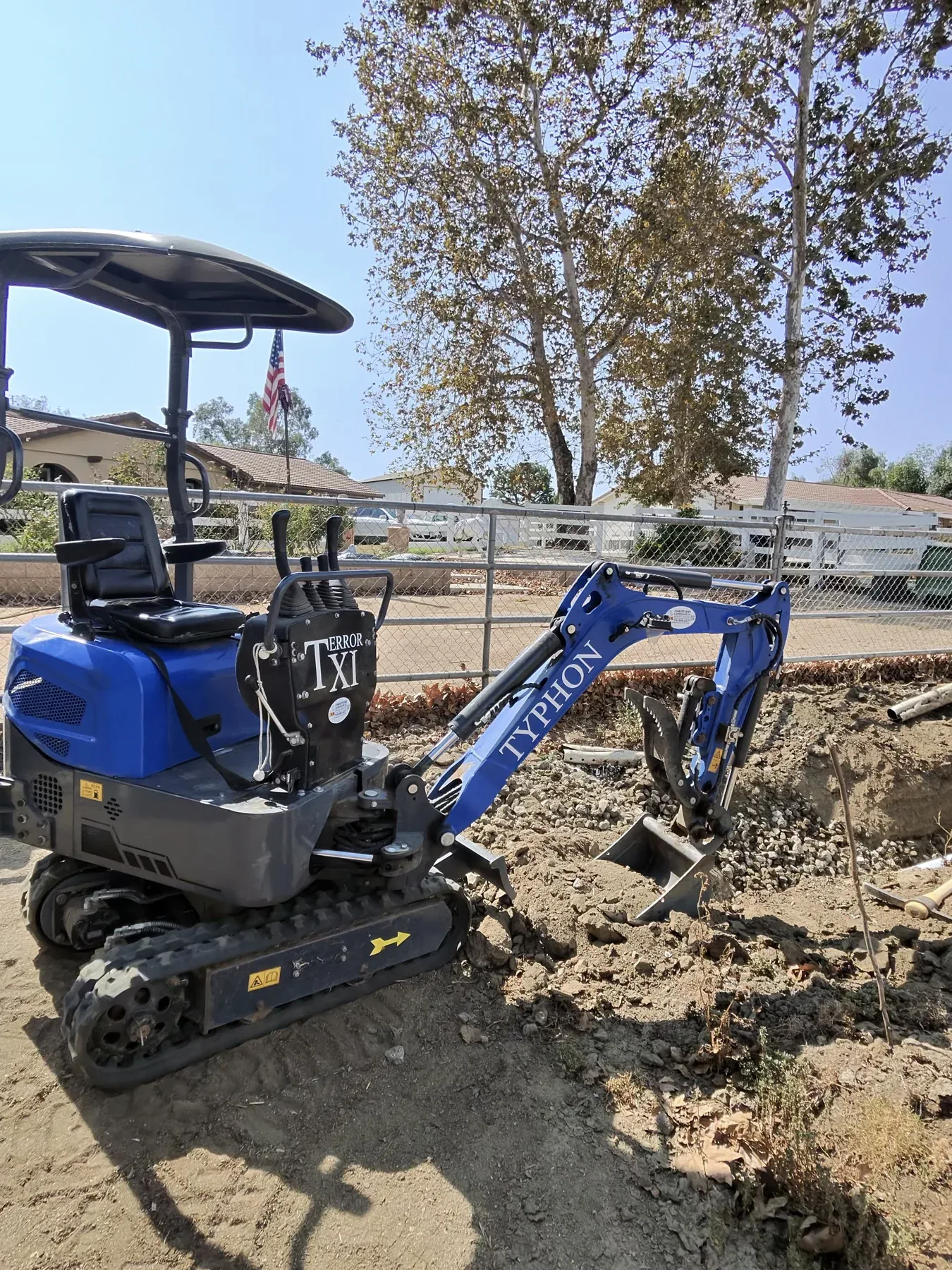 Mini excavator on site during a drainage repair project